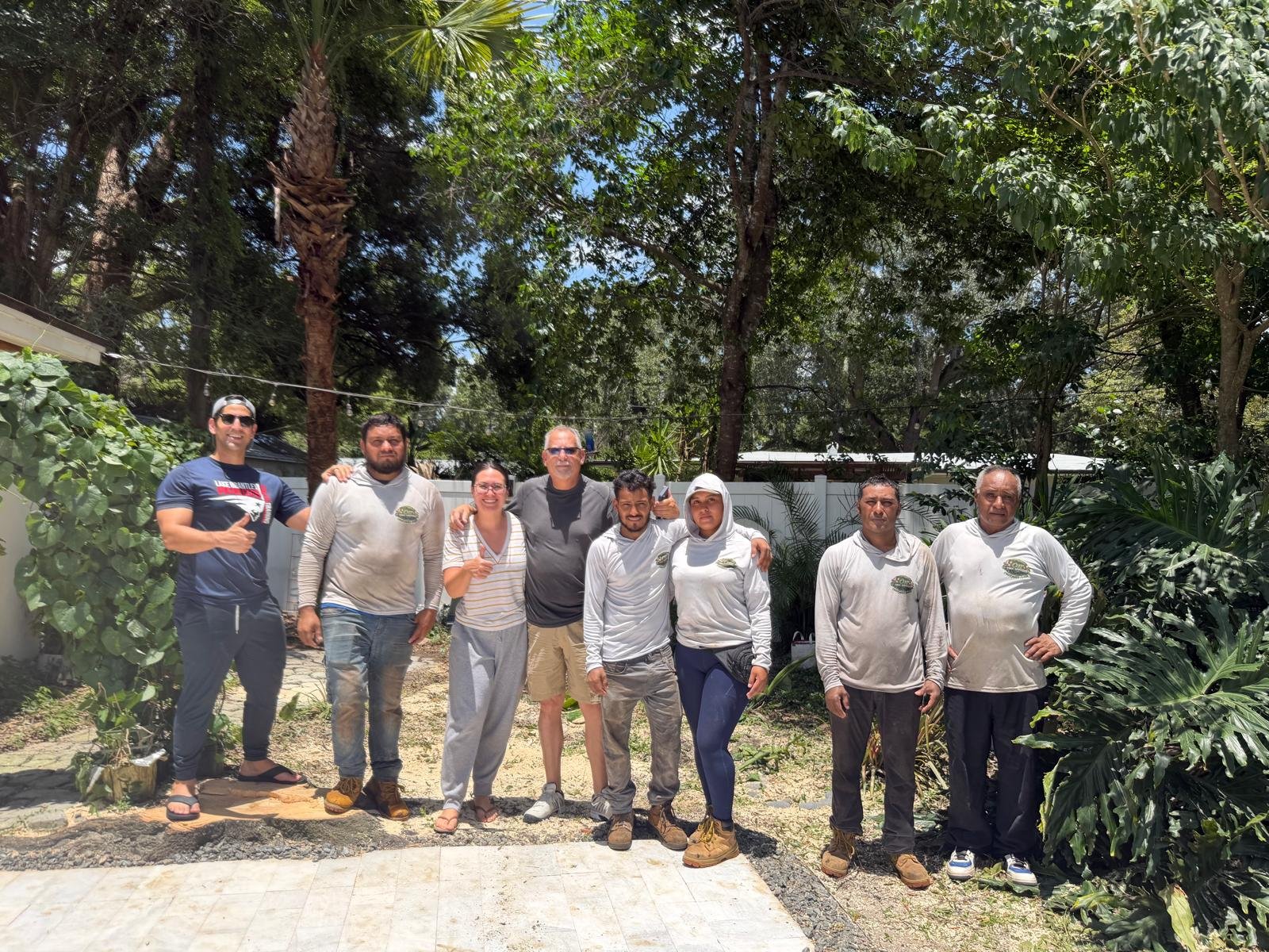 Eight people standing together outdoors
